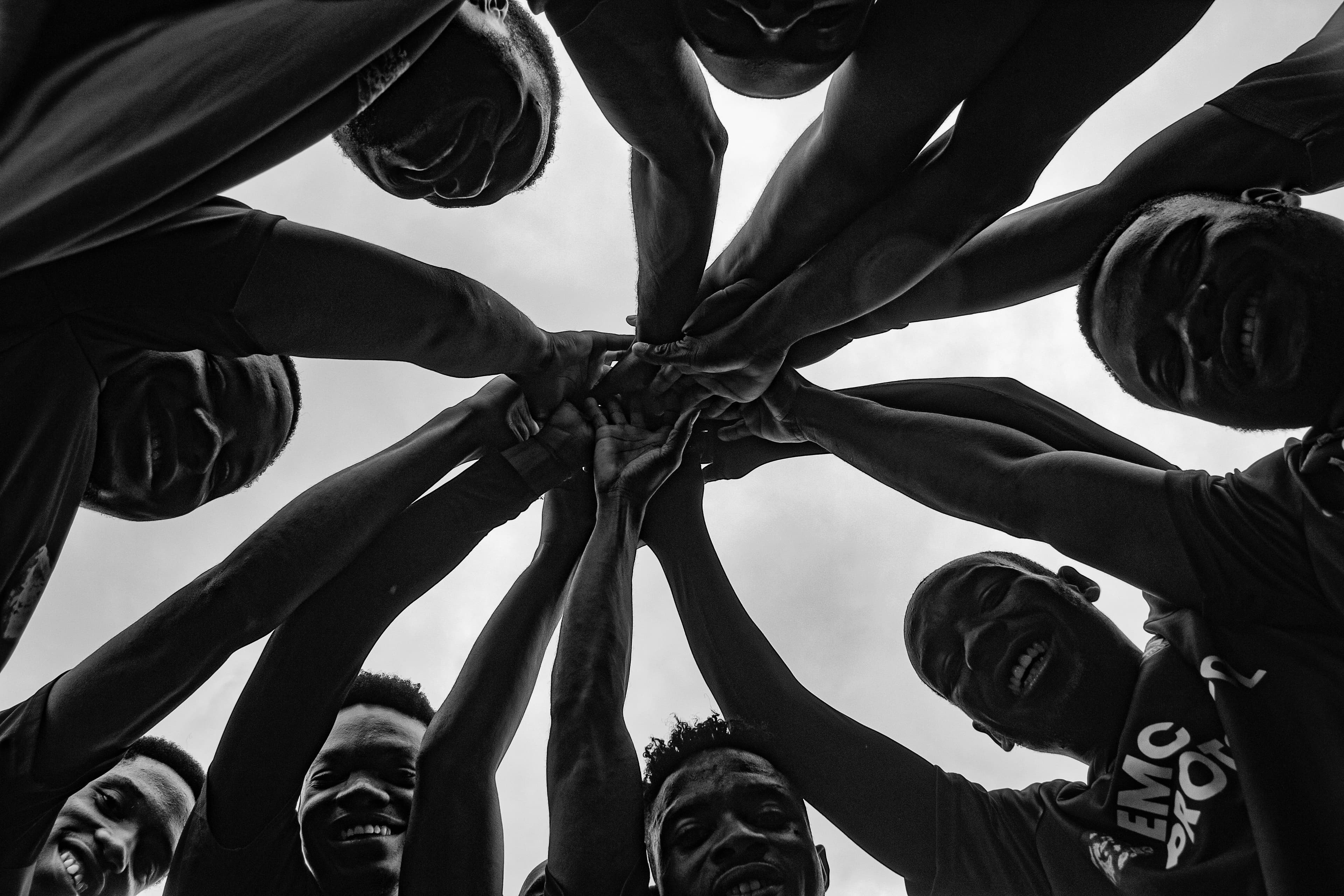 Friends joining hands together